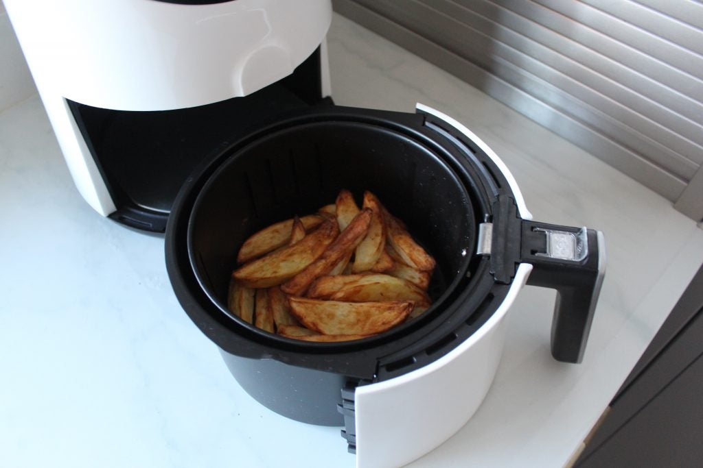 Nahaufnahme eines Behälters einer Quest Digital LCD Air Fryer mit darin aufbewahrten frittierten Pommes Frites