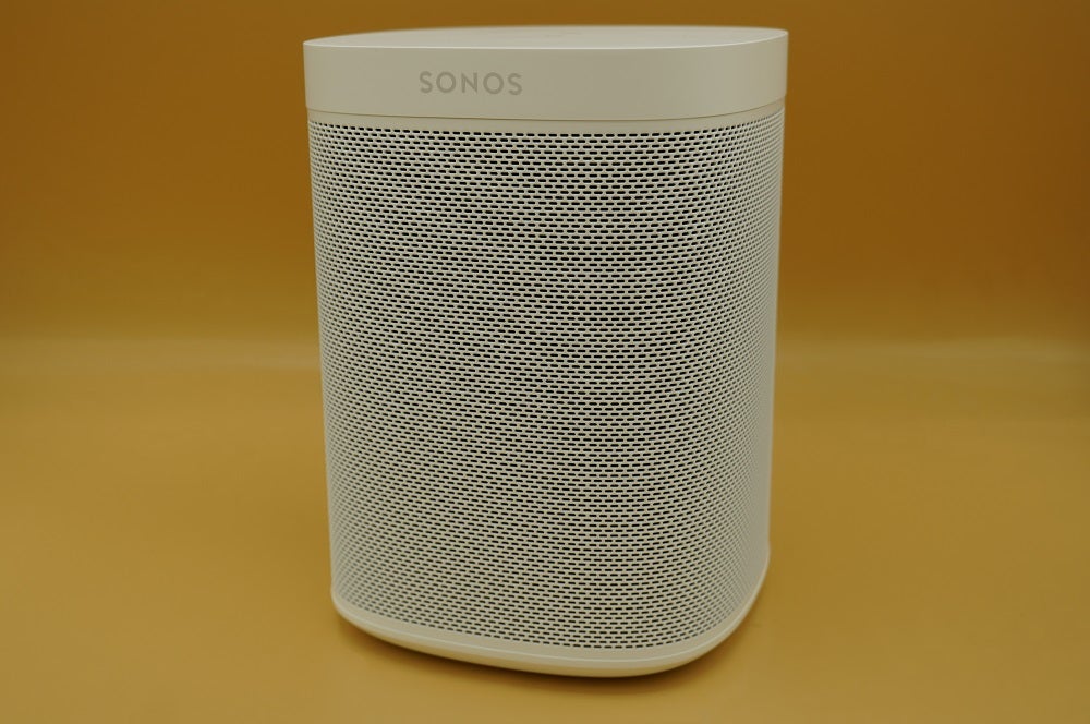 Ein weißer Sonos One SL Lautsprecher steht auf einem Tisch