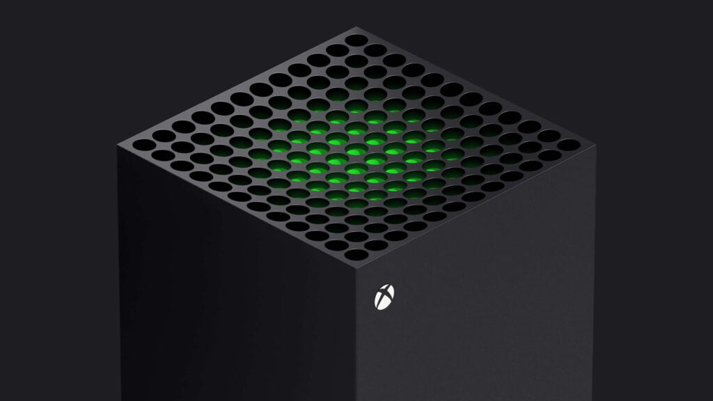 Vordere Draufsicht einer schwarzen Xbox, die auf schwarzem Hintergrund steht